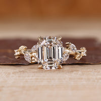 Nature inspired engagement ring with emerald old European cut centre.