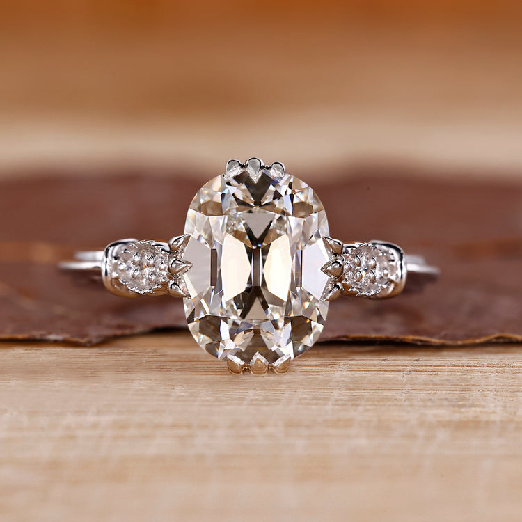 Cushion Old European Cut Ring with round side stones.