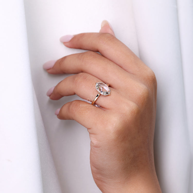 Oval rose cut ring compass prong open gallery style.