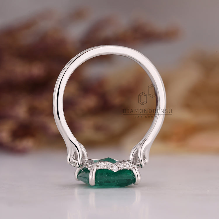 Emerald gemstone ring hidden halo tapered shank set.