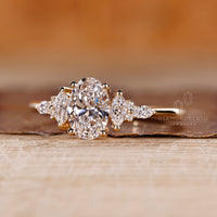 Oval diamond ring marquise round stones prong set.