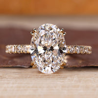 Hidden halo engagement ring with oval cut centre stone.
