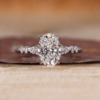 Oval diamond ring pear round side stones cathedral.