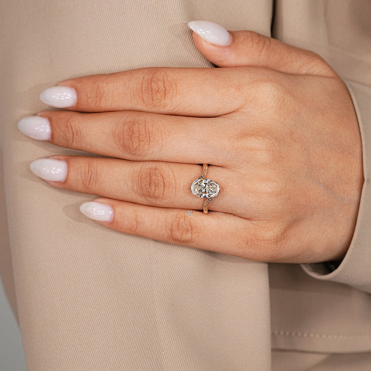 Handmade oval solitaire ring with milgrain detailing.