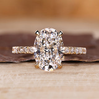 Oval cut diamond ring pave hidden halo four claw set.