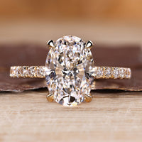 Oval cut diamond ring pave hidden halo four claw set.