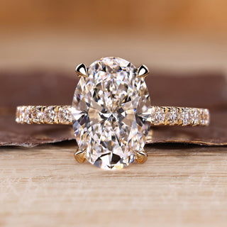 Oval cut diamond ring pave hidden halo four claw set.
