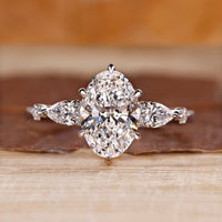 Oval cut diamond ring with pear and round side stones.
