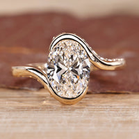 Oval cut diamond ring hidden pave half bezel bypass.