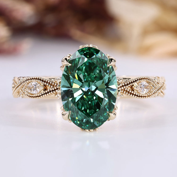 Oval diamond ring with green diamond and side stones.