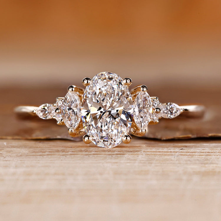 Oval cut diamond ring marquise round muse tapered shank.