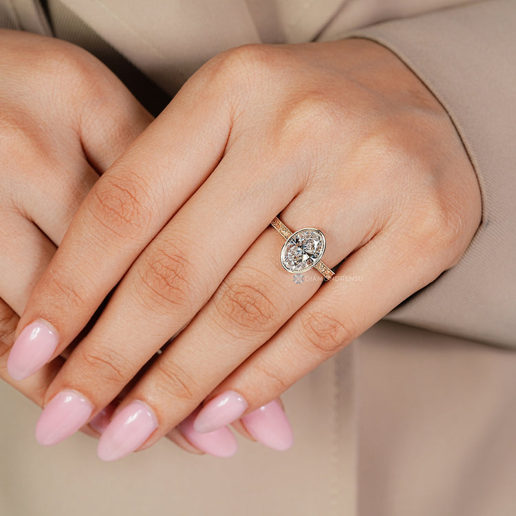 Handmade oval cut diamond ring with milgrain setting.