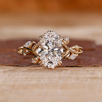 Oval cut diamond ring marquise round cluster leaf prong.