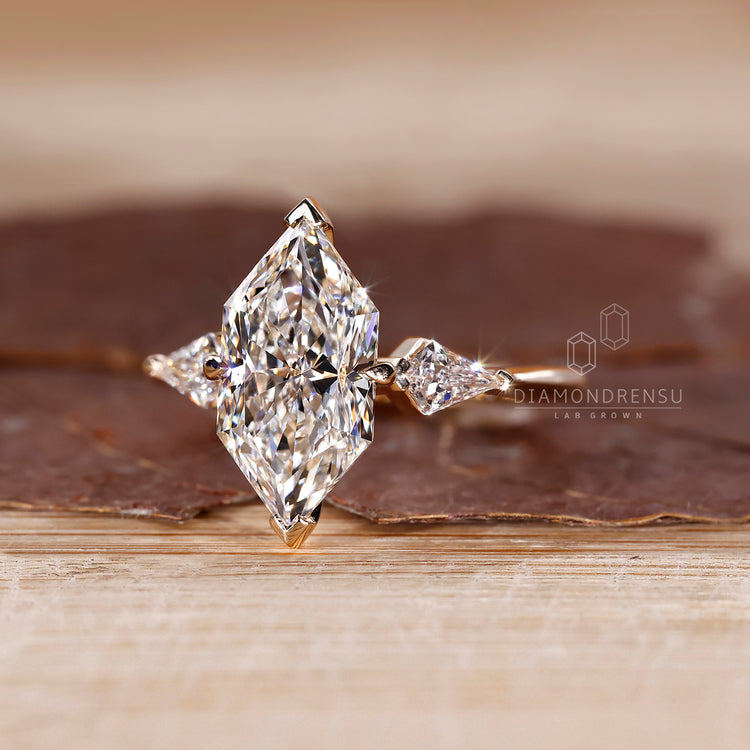 V and Claw Prong Ring with kite cut and marquise diamonds.
