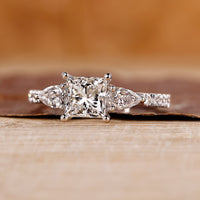 Princess cut diamond engagement ring with pave setting ring.
