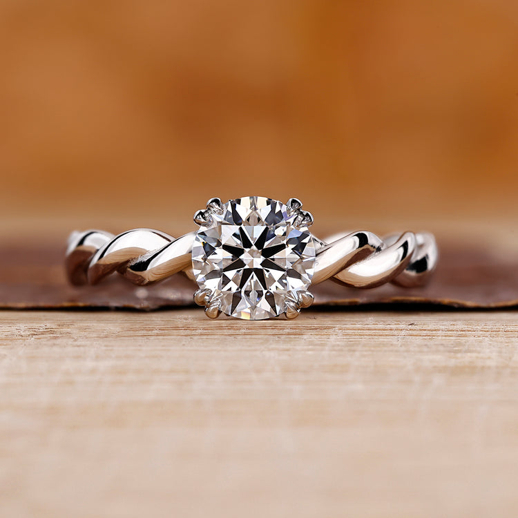 Round cut diamond ring with hidden halo design.