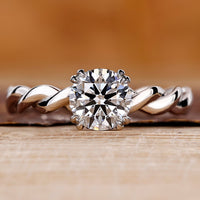 Round cut diamond ring with hidden halo design.