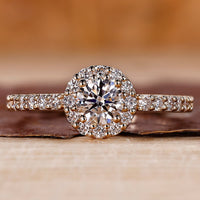 Round halo diamond ring in yellow gold with pave setting.