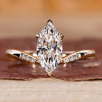 Marquise engagement ring with tapered shank band.
