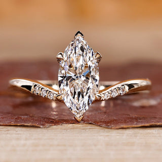 Marquise engagement ring with tapered shank band.