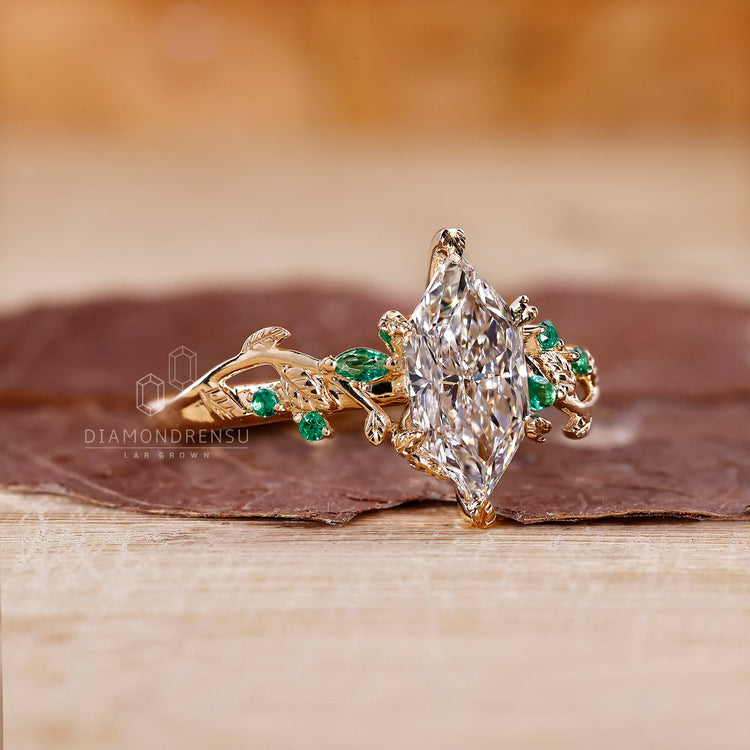 Yellow gold engagement ring with emerald side diamond.
