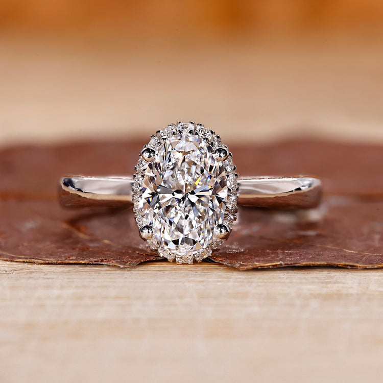 Halo diamond engagement ring and oval cut diamond ring.