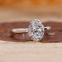 Oval cut diamond ring with tapered shank band.
