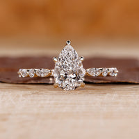 Pear shaped engagement ring with hidden halo.
