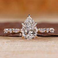 Pear shaped engagement ring with hidden halo.