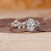 Vine engagement ring made with marquise and round side stone.