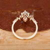 Prong Setting Ring with pear and round side accents.