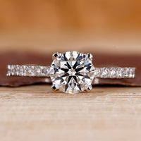 Pave engagement ring with round diamond center.