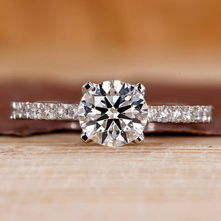 Pave engagement ring with round diamond center.