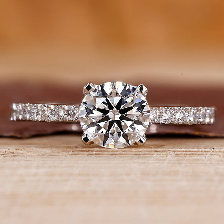 Pave engagement ring with round diamond center.