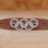 Round diamond engagement ring with Diamond Olympic Ring.
