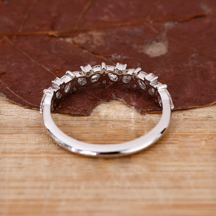 Shared Prong Band in white gold half eternity style.