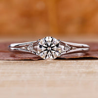 Split shank engagement ring with round cut diamond centre.