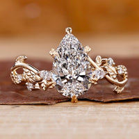 Pear shaped engagement ring in yellow gold diamond ring.