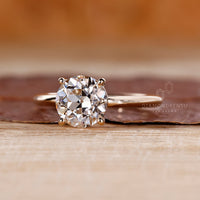 Solitaire round old European cut ring four prong set.