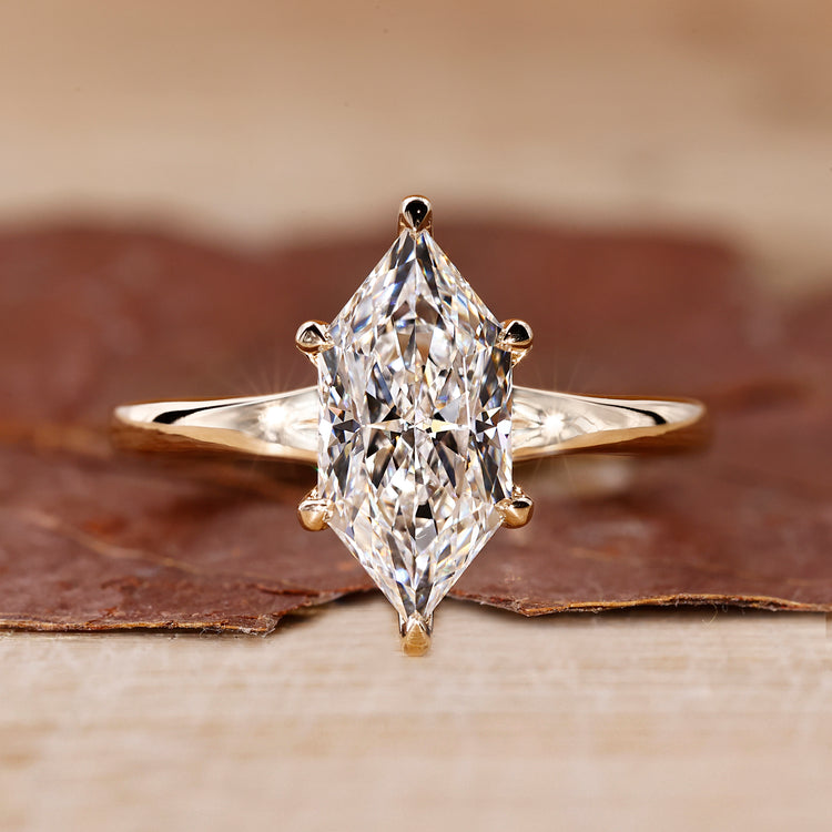Yellow gold solitaire engagement ring with Dutch marquise cut diamond.