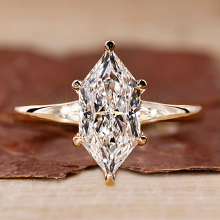 Yellow gold solitaire engagement ring with Dutch marquise cut diamond.