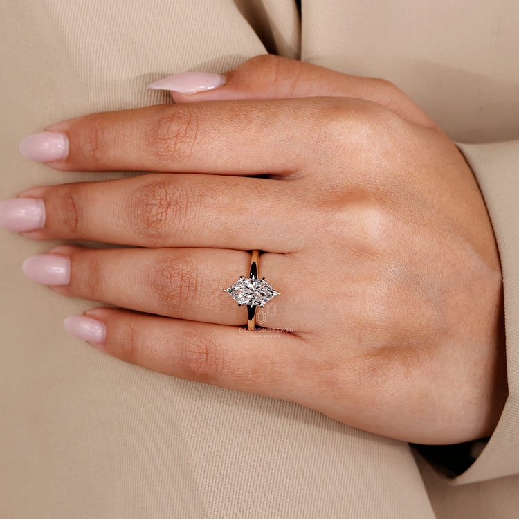 Custom diamond solitaire ring with marquise cut stone.