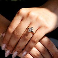 Solitaire engagement ring with 6 claw prong setting in gold.