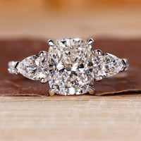 Cushion cut engagement ring with pave setting ring.