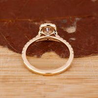 Round Diamond Ring with 4 claw prong and halo setting.