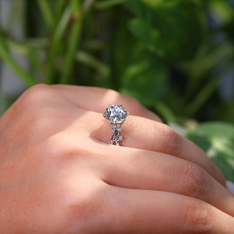 Marquise and round side stone in white gold engagement ring.