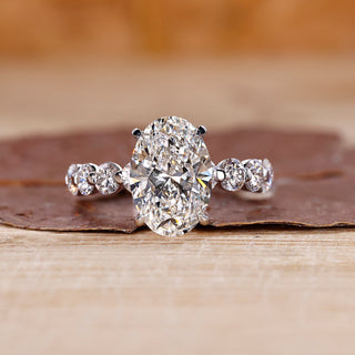 Oval diamond engagement ring with floating bubble prong.