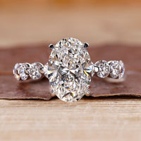Oval diamond engagement ring with floating bubble prong.