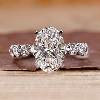 Oval diamond engagement ring with floating bubble prong.