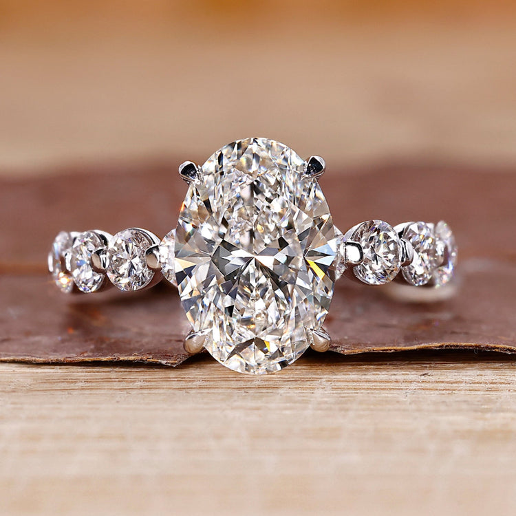 Oval diamond engagement ring with floating bubble prong.